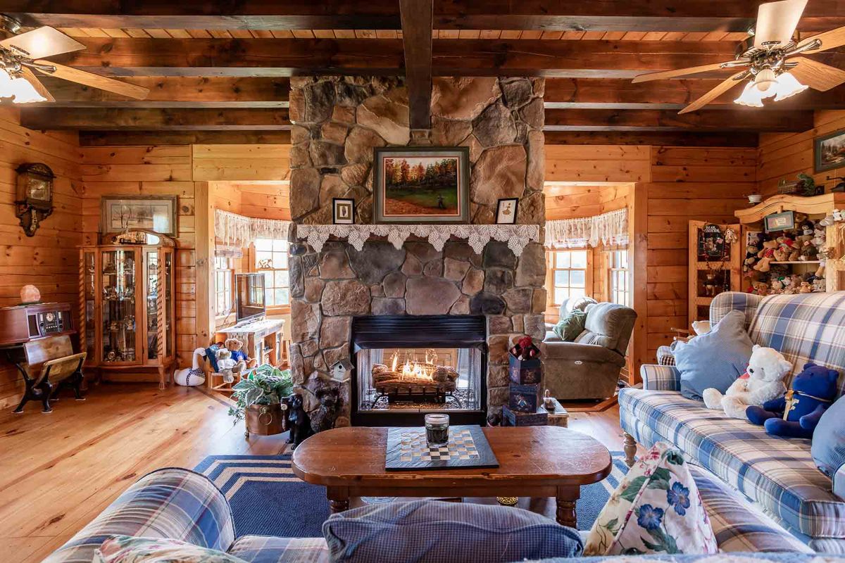 Interior photography  -  log cabin living room with stone fireplace
