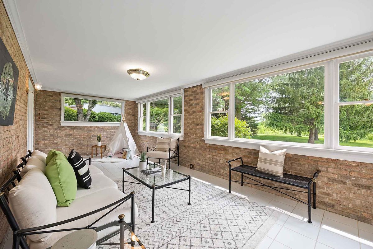 Interior photography  -  sunroom with exposed brick and garden views