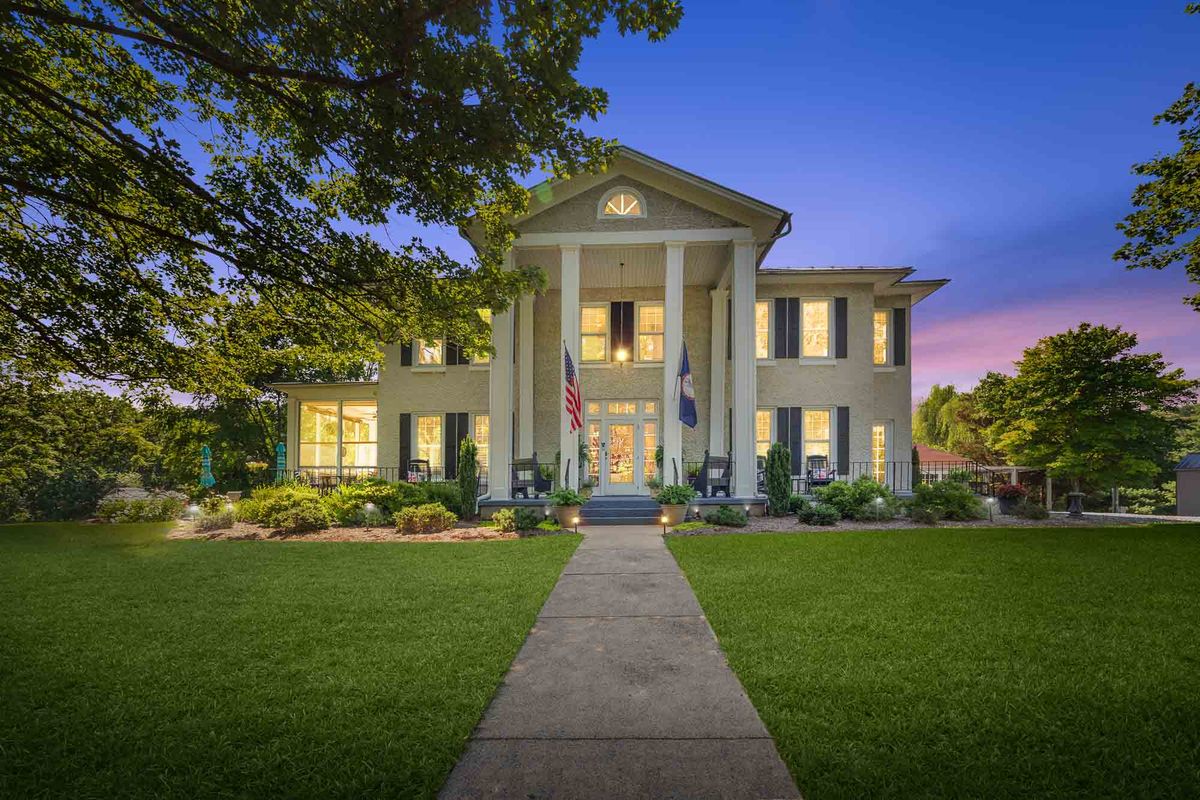Blue hour real estate photography  -  Greek Revival home lit at twilight